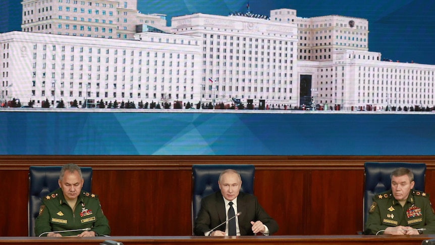 Russian president Vladimir Putin seated centre, left is Defence Minister Sergei Shogiu, right is army chief Valery Gerasimov.