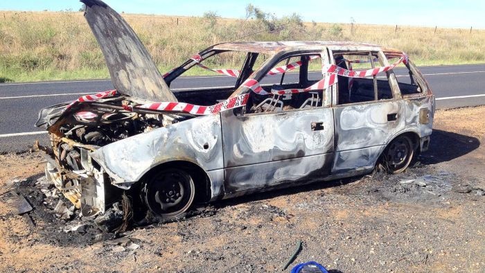 White car burnt out by the roadside