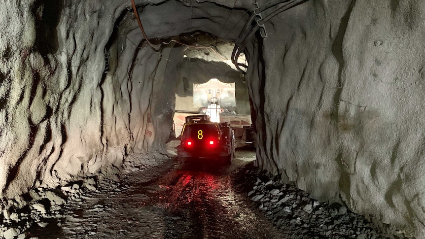 Underground in the Ballarat gold mine. A machine dumps material into a truck.