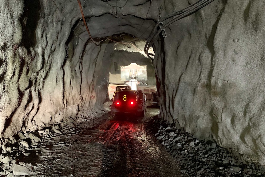 Underground in the Ballarat gold mine. A machine dumps material into a truck.