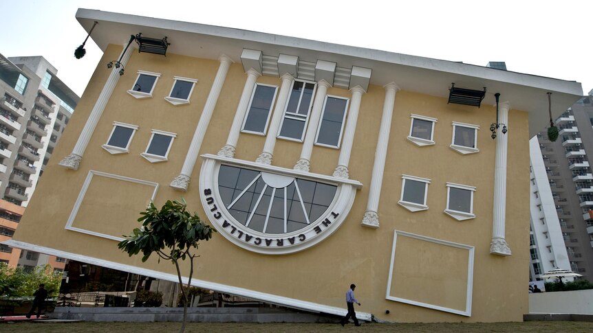 A man walks past the newly constructed upside down clubhouse in Indirapuram, India.