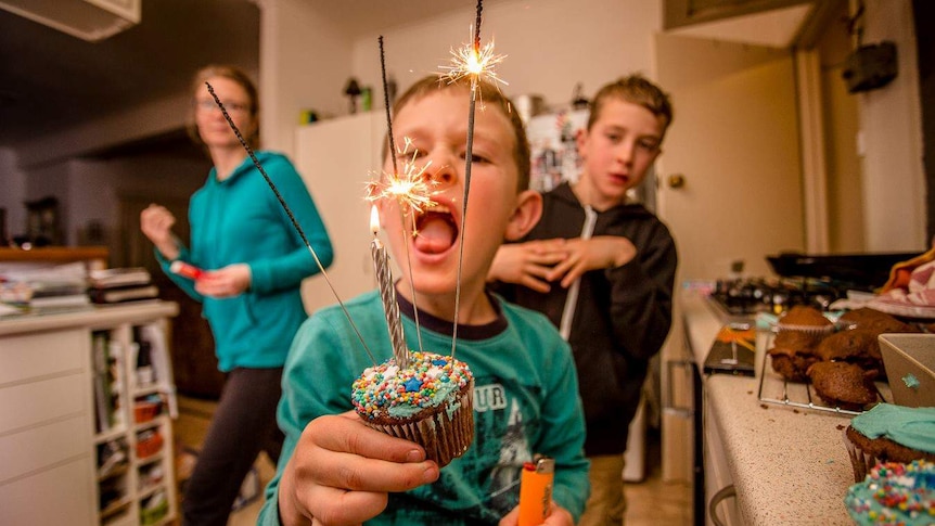 Drew Chislett's son blowing out a sparkler on a cup-cake for his birthday.