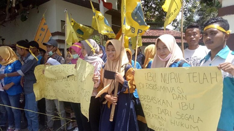 Dozens of students holding flags and banners said Baiq Nuril has been criminalised