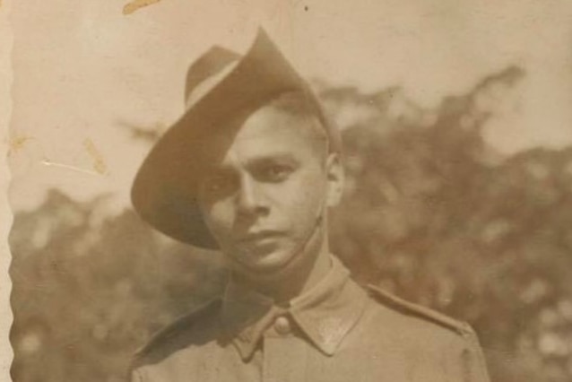 Old sepia photograph of a young Indigenous man in military uniform