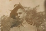 Old sepia photograph of a young Indigenous man in military uniform