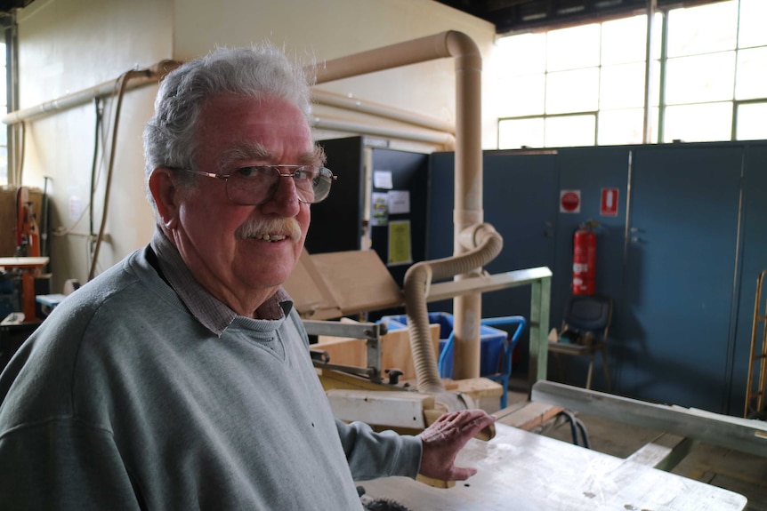 66 year old Alan Davis stands in front of wood cutting machinery at the East Ballarat Men's Shed.