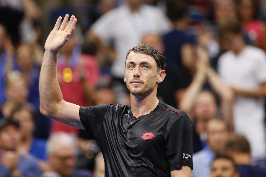 John Millman waves to the crowd after defeating Roger Federer at the US Open.