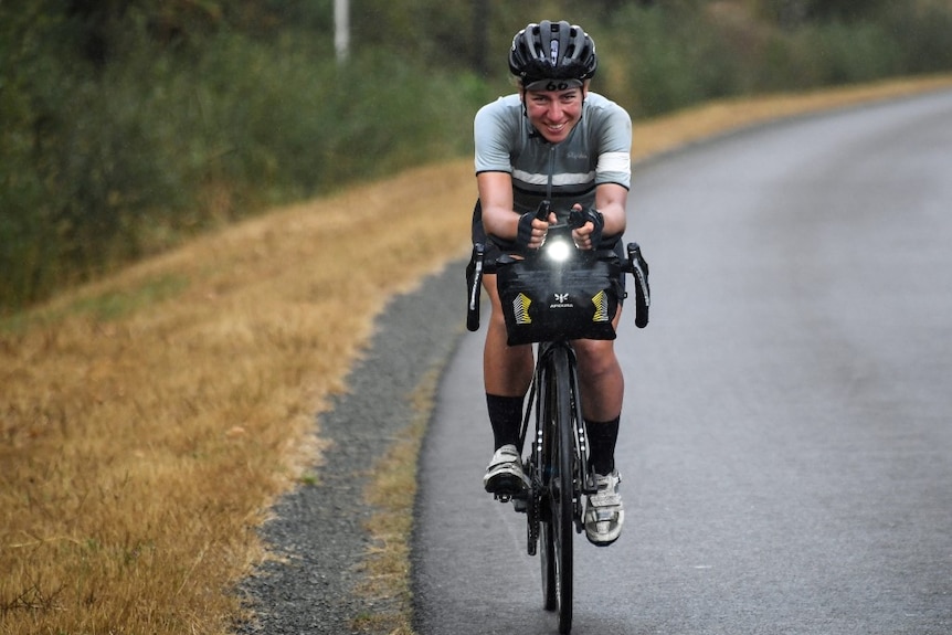 Fiona Kolbinger smiles as she rides her bike