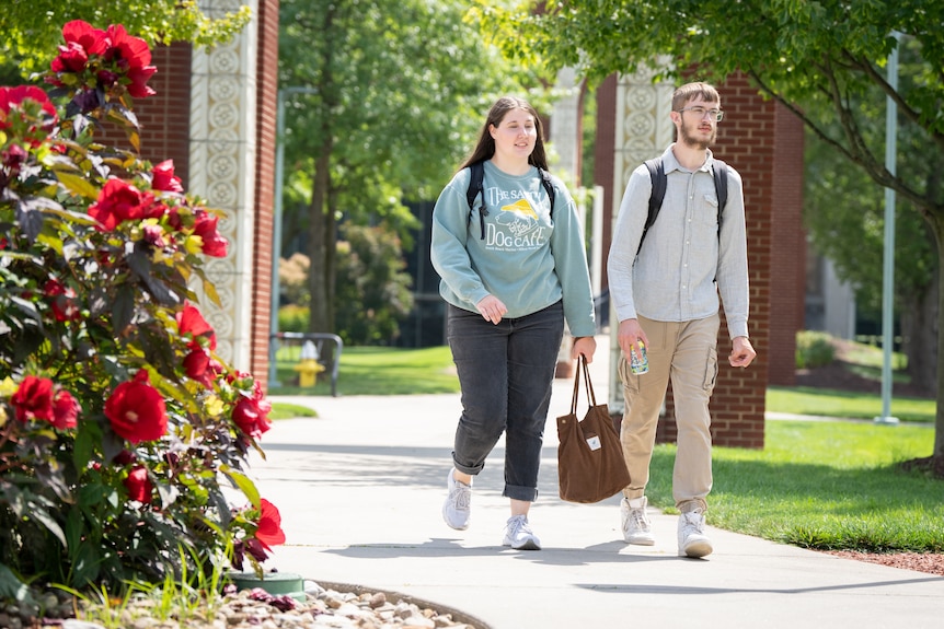 Two students walking on campus.