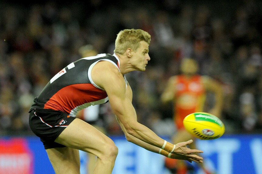 St Kilda's Nick Riewoldt falls over taking a mark against Gold Coast at Docklands.