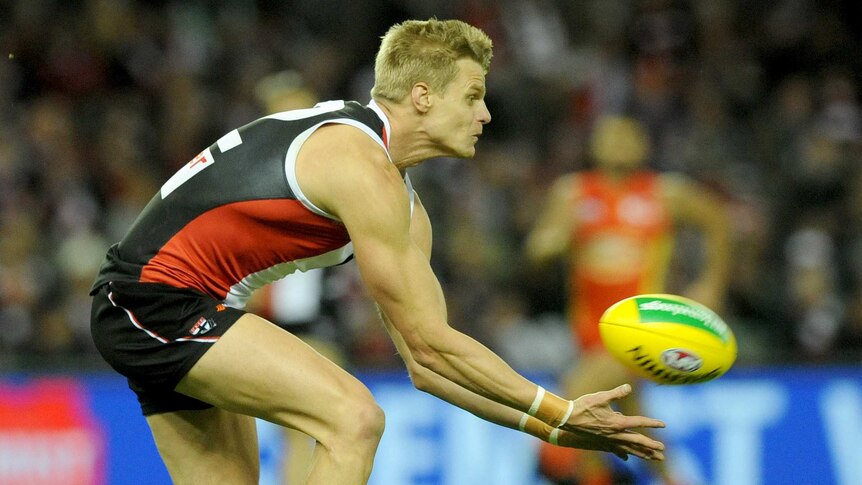 Nick Riewoldt falls over taking a mark for St Kilda
