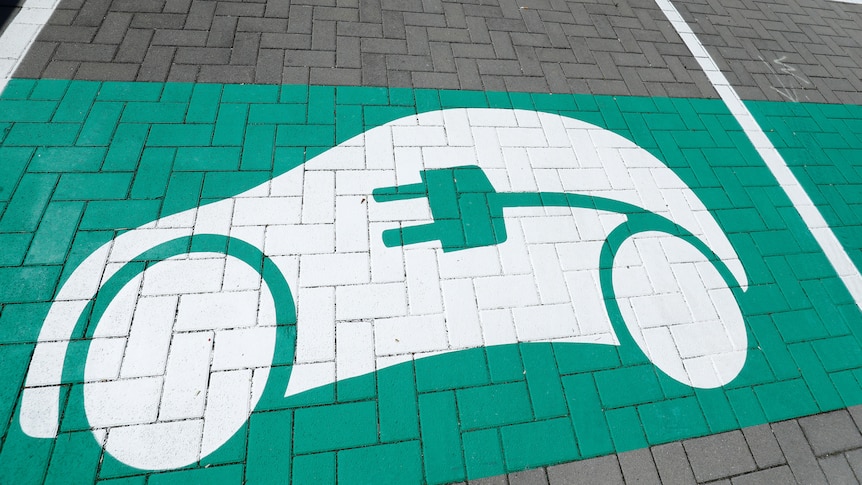 A green car painting on a parking spot.