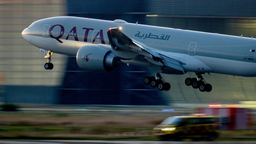 A photo of a Qatar Airways plane taking off.