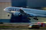 A photo of a Qatar Airways plane taking off.