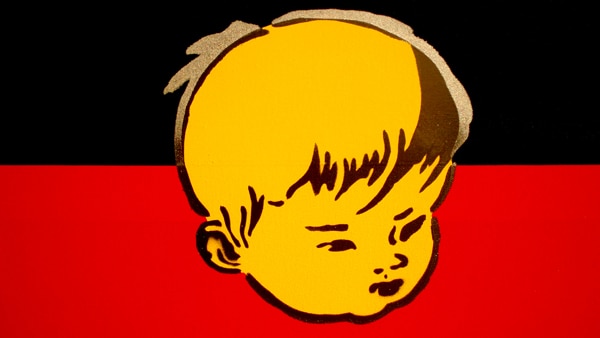 A painting of an Aboriginal flag with the face of a Chinese boy