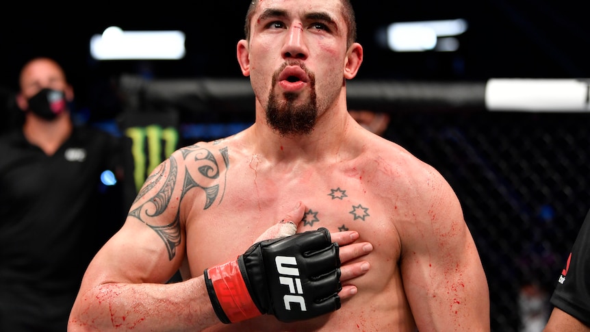 Robert Whittaker celebrates after the conclusion of his middleweight fight against Darren Till 