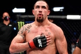 Robert Whittaker celebrates after the conclusion of his middleweight fight against Darren Till 