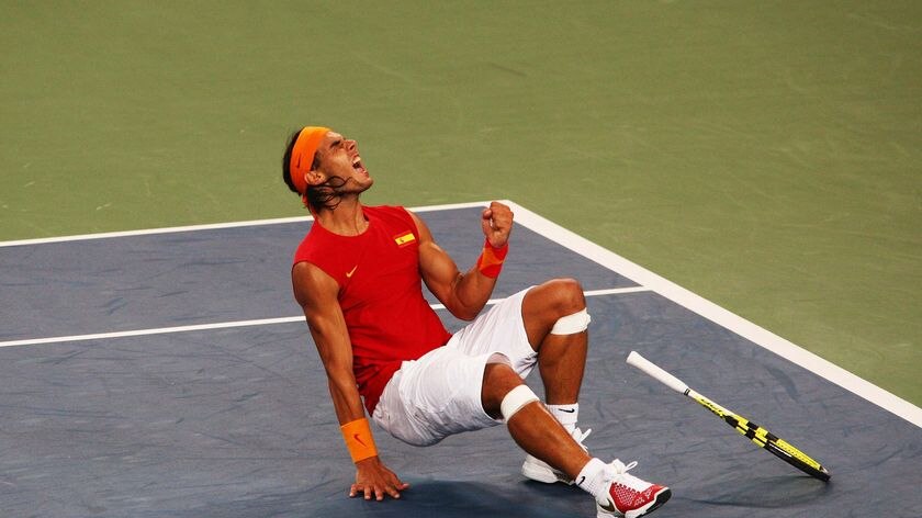 Rafael Nadal celebrates winning the gold medal against Fernando Gonzalez in the men's singles tennis