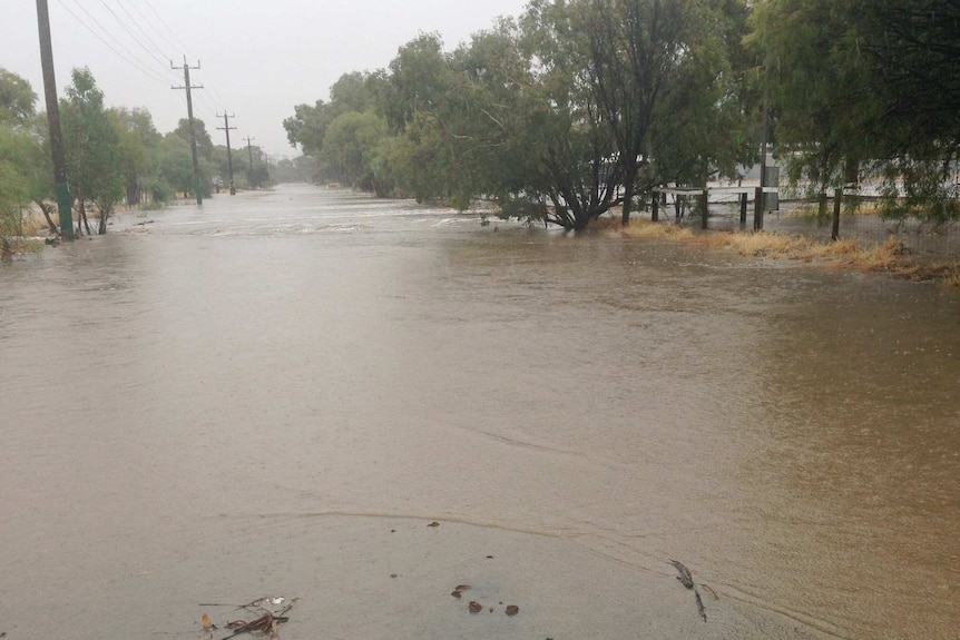 A country road lies under water after being flooded.