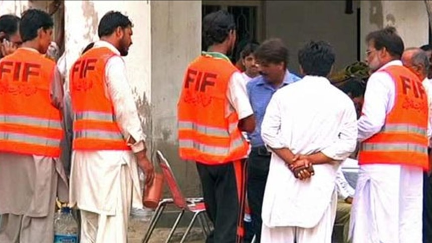 FIF 'officials' speak to residents at a camp in Sukkur, Pakistan