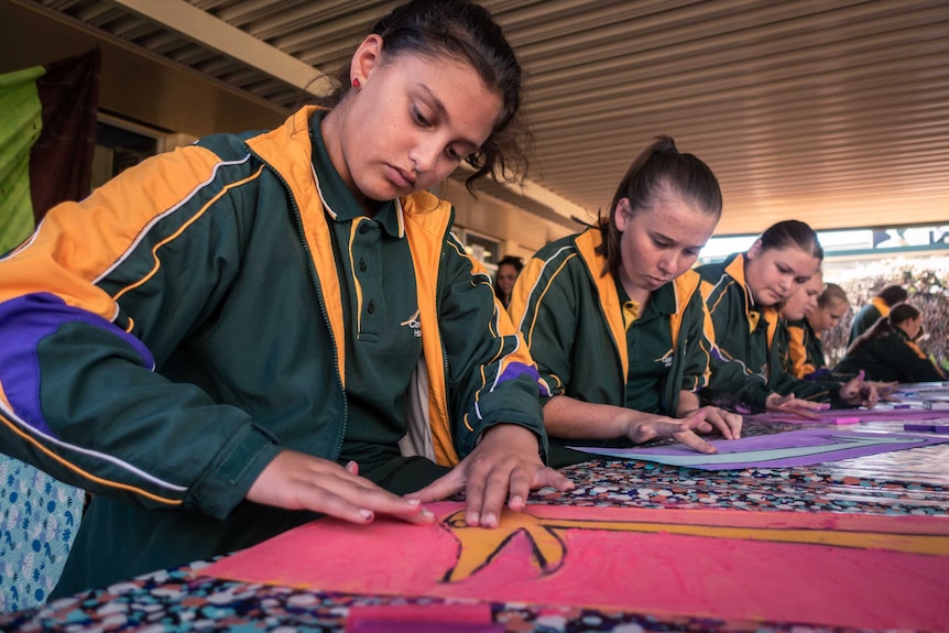 Students draw in an art therapy workshop.