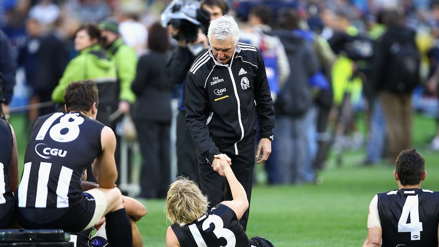 A Magpie no more ... Mick Malthouse shakes Dale Thomas's hand after Collingwood's grand final loss.
