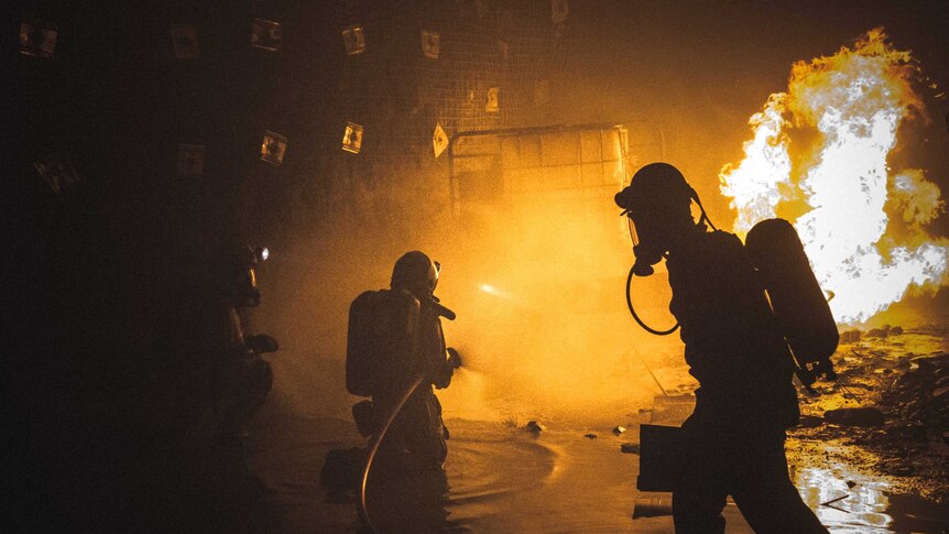 Mine rescue personnel fight an underground fire during a training exercise.