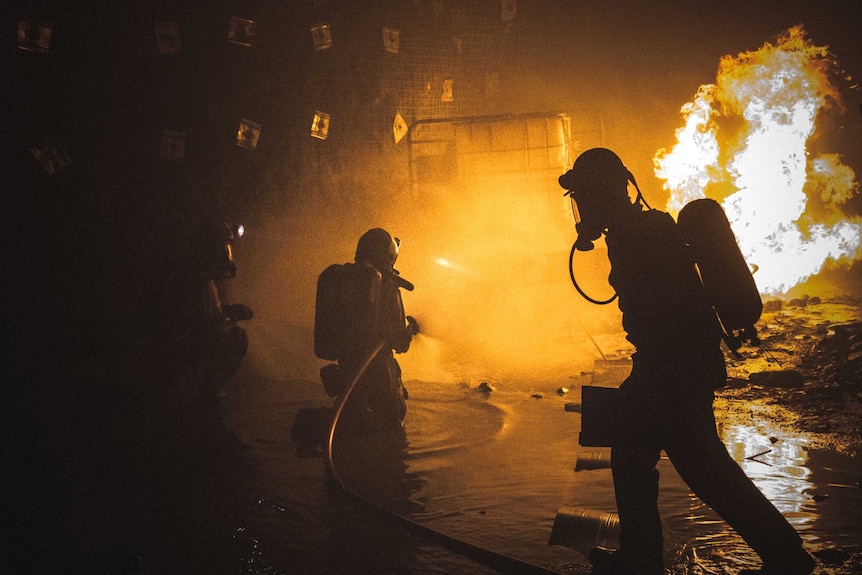 Mine rescue personnel fight an underground fire during a training exercise.