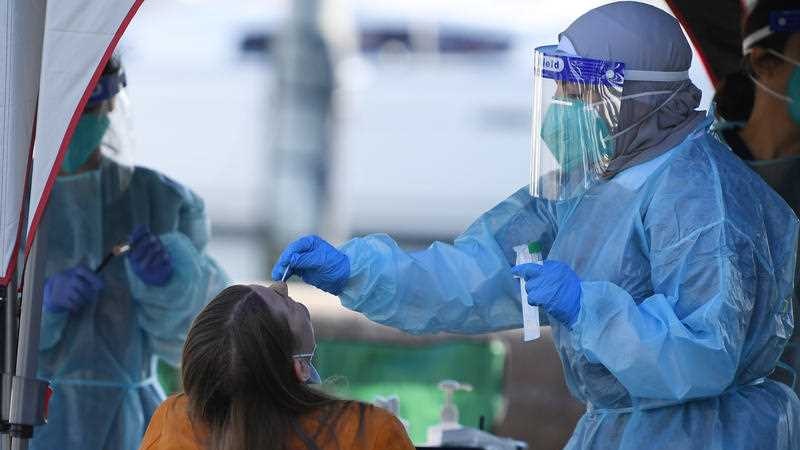 A person in hazmat suit doing a coronavirus swab.
