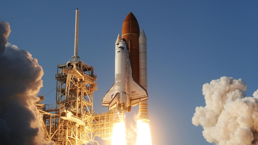 The space shuttle Discovery lifts off