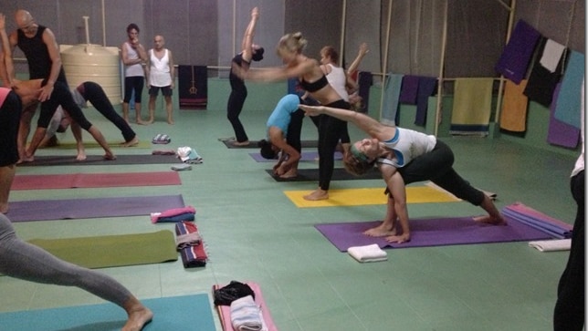Heather Eldridge practicing yoga at a Lino Miele workshop at Kovolam, India.