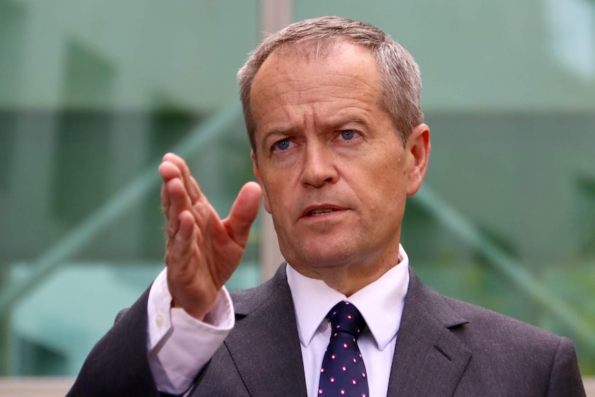 Upper body photo of Bill Shorten pointing directly ahead as he speaks.