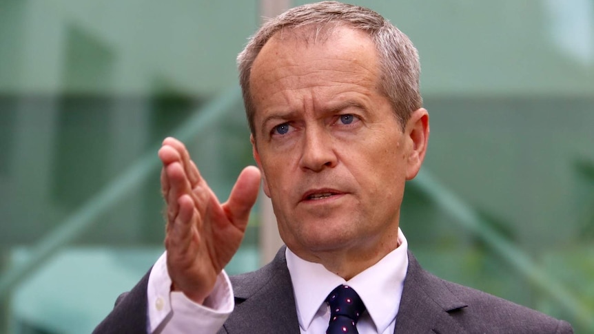 Upper body photo of Bill Shorten pointing directly ahead as he speaks.