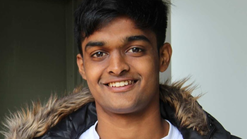 A head and shoulders shot of young Tasmanian resident Raigama Wijeratne. He is smiling
