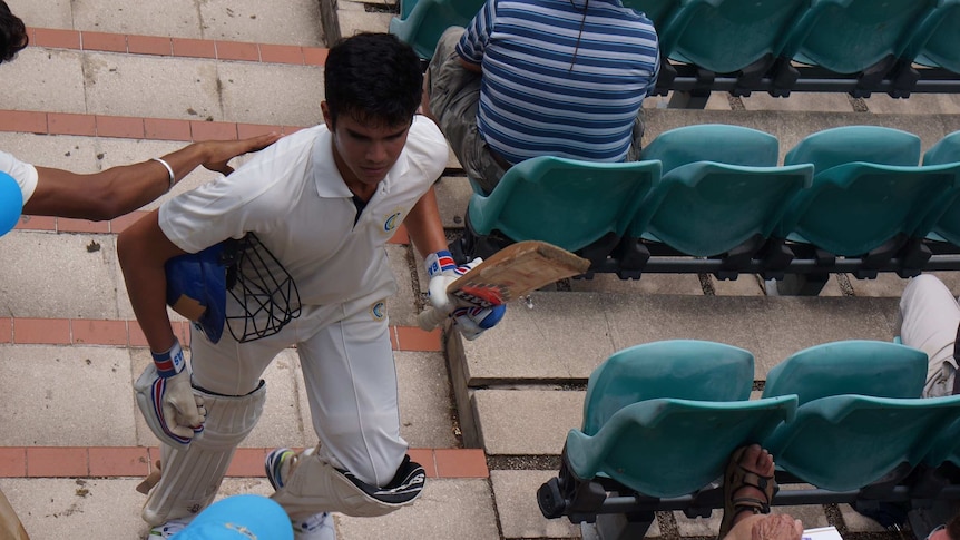 Arjun Tendulkar walks up stairs after playing at the Bradman Oval.