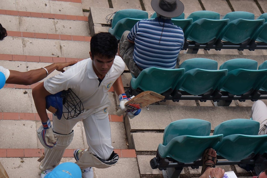 Arjun Tendulkar walks up stairs after playing at the Bradman Oval.