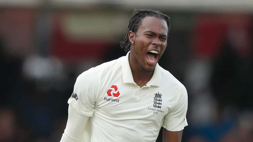 Jofra Archer spreads his arms and roars as he celebrates the wicket of David Warner