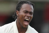 Jofra Archer spreads his arms and roars as he celebrates the wicket of David Warner