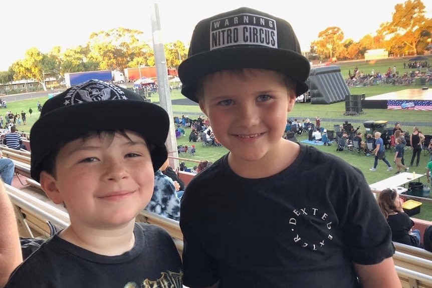 Two young boys smile into the camera.