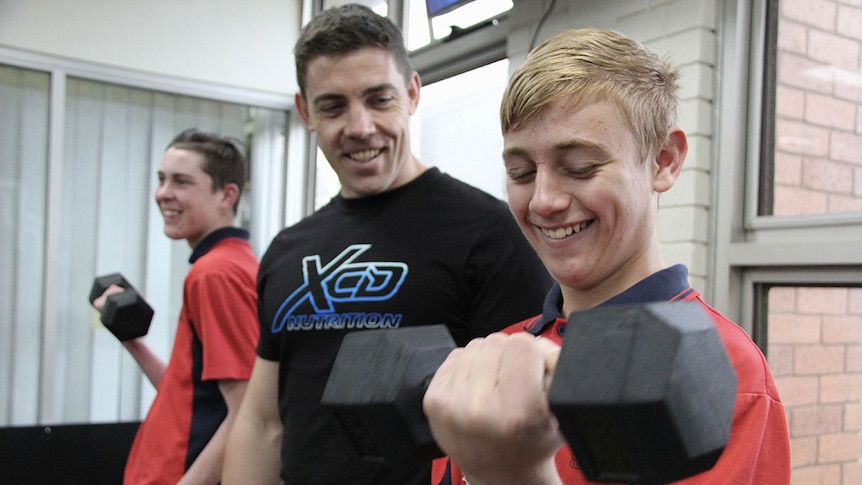 Joshua Praeger (centre), with 15-year-old Zac Agoston (right) and another student