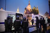 Protesters can be seen in a dark van as St Basil's Cathedral is lit up in the background