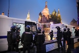 Protesters can be seen in a dark van as St Basil's Cathedral is lit up in the background