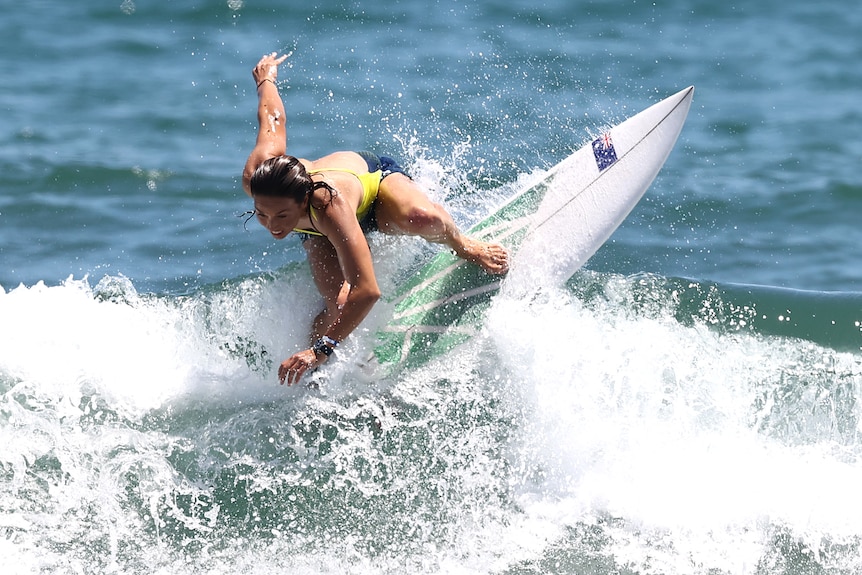 An Australian female surfer riding a wave during a training session in Japan.