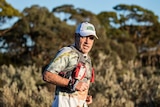 A marathon runner in a race in the Australian bush.