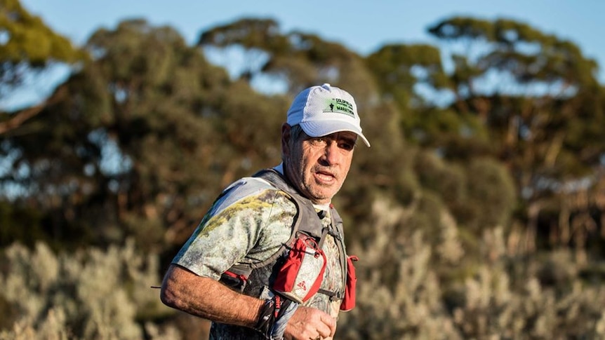 A marathon runner in a race in the Australian bush.