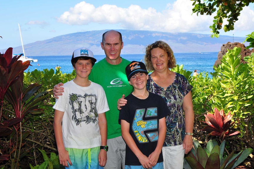 A picture of the Wade family in front of the coast.