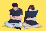 A man and a women sitting next to each other and both hugging a pillow for a story about how to find the right pillow for you.
