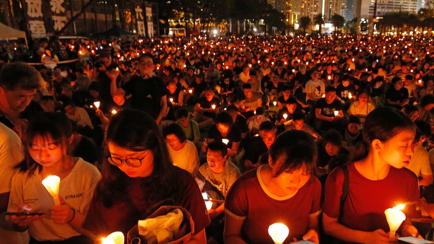 Thousands of people holding a candle at night in Hong Kong.
