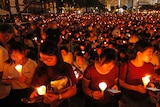 Thousands of people holding a candle at night in Hong Kong.
