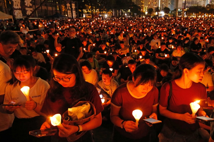 Thousands of people holding a candle at night in Hong Kong.